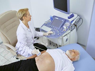 An oncologist discusses a liver cancer treatment plan with a patient at the clinic