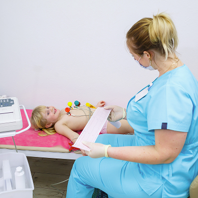 Girl shows a certificate of admission to kindergarten after a medical examination