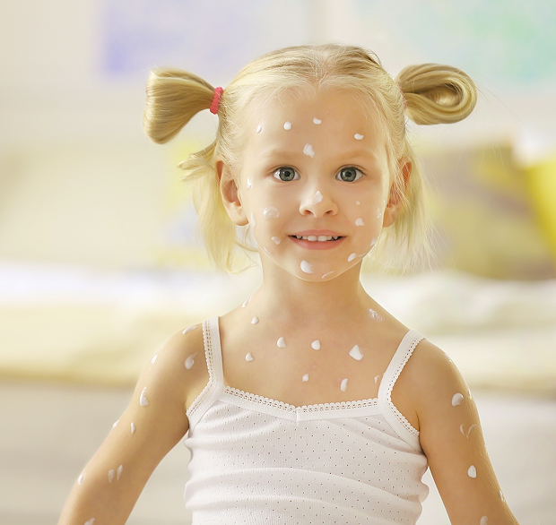 An adolescent dermatologist consults a boy with a rash on his face.