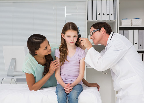 An ENT doctor tests a child's hearing during an appointment at a Moscow pediatric ENT clinic