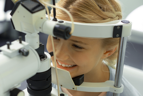 Parents with a child at a consultation with a pediatric ophthalmologist.