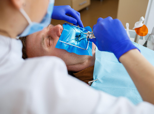 How is a dystopic tooth removed?